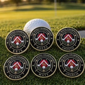 May include: Six circular metal golf ball markers with a black, red, and gold design. Each marker features the text THE ROYAL CHAMPIONSHIP, a central crest with a lion, and a unique name: KRIS, MOZZA, SMEETH, STUBBS, MATT, or CHARLIE.