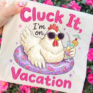 May include: A cream-colored tote bag with a whimsical illustration of a chicken wearing sunglasses and floating on a watermelon-themed inner tube. The text reads "Cluck It, I'm on Vacation" in pink. The chicken holds a colorful cocktail.