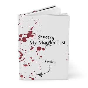 May include: A white notebook with red splatter paint and the text "grocery My Murder List" with the word "grocery" crossed out. The text "ketchup" is written below with an arrow pointing to it.