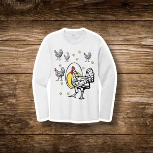 May include: White long-sleeve shirt featuring a whimsical chicken and egg design. The graphic includes a large chicken illustration with a red comb, a yellow egg, and several smaller chicken and egg illustrations. The shirt is made of a soft material.