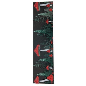 May include: A black and green patterned fabric with red mushrooms. The fabric has a repeating pattern of mushrooms and trees.