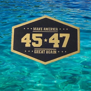 May include: A black and gold hexagonal patch with the text "MAKE AMERICA" above the numbers "45*47" and the words "GREAT AGAIN" below. The background is a blue and turquoise water scene.