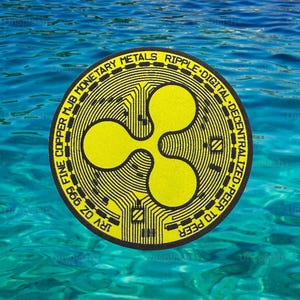 May include: A yellow Ripple digital currency coin with a distinctive logo, set against a backdrop of blue water. The coin's design includes text around the edge, with the words "FINE COPPER MJB MONETARY METALS RIPPLE DIGITAL DECENTRALIZED PEER TO PEER".