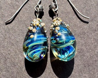 Blue glass swirl drop earrings with barnacle caps