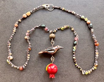 Flamework Raven Pendant with pomegranate drop.