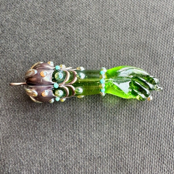 green glass figa hand charm with golden and turquoise glass “jewels”