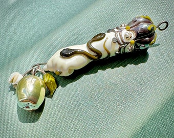 Glass Hand with snake holding iridescent Apple charm