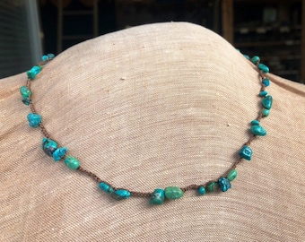 Turquoise beads on a brown crochet silk chain.