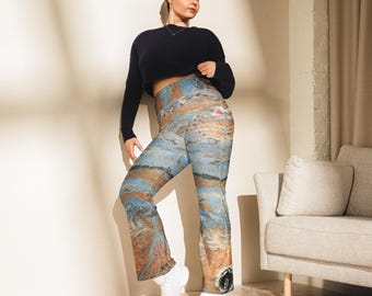 May include: A woman wearing a navy blue long-sleeved shirt and blue, brown, and white patterned pants. The pants have a high waist and a wide leg.