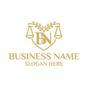 Puede incluir: Un logotipo dorado con las letras "BN" dentro de una forma de corazón con una balanza de justicia a cada lado y una corona de laurel arriba. El texto "BUSINESS NAME" y "SLOGAN HERE" está debajo del logotipo.