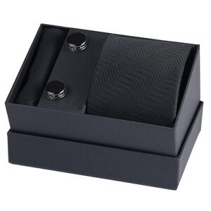 May include: A black gift box containing a black tie, a black pocket square, and two black cufflinks.