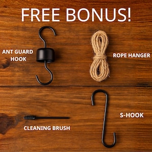 May include: Image of a collection of accessories, including an ant guard hook, rope hanger, cleaning brush, and S-hook. The items are black and brown, with the text "FREE BONUS!" in white.