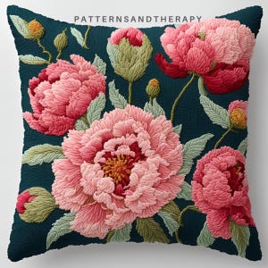 May include: A teal blue cushion with a floral design featuring pink peonies and green leaves. The text "PATTERNSANDTHERAPY" is printed in white at the top of the cushion.