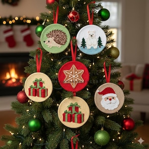 May include: A collection of round Christmas ornaments with red ribbon hangers. The ornaments feature embroidered designs of a hedgehog, polar bear, gifts, a star, and Santa Claus. The ornaments are displayed on a decorated Christmas tree.