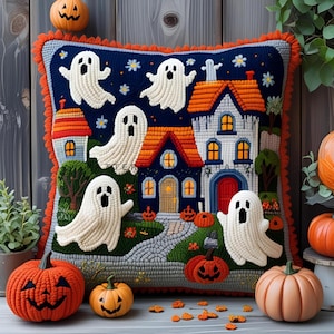 May include: A Halloween-themed decorative pillow featuring a haunted house scene with white ghosts, orange pumpkins, and a dark blue background. The pillow has an orange fringe and is surrounded by carved pumpkins.