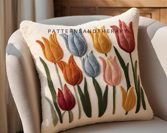 May include: A white throw pillow with embroidered colorful tulips in shades of red, orange, yellow, blue, and pink. The pillow has a fluffy texture and is perfect for adding a touch of spring to any room.