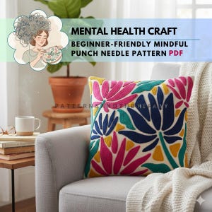 May include: A decorative pillow with a colorful floral design in pink, blue, yellow, and green. The pillow is on a gray armchair. The image includes text that reads "MENTAL HEALTH CRAFT, BEGINNER-FRIENDLY MINDFUL PUNCH NEEDLE PATTERN PDF."