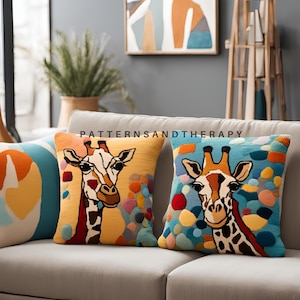 May include: Two colorful throw pillows with a giraffe design. The pillows are on a light brown couch. The pillows have a yellow background with colorful abstract shapes and a giraffe face in the center. The text "PATTERNSANDTHERAPY" is printed on the couch.