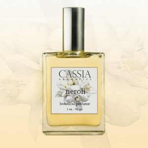 May include: A clear glass bottle of Cassia Aromatics neroli botanical perfume. The bottle has a silver cap and a white label with the brand name, product name, and description: "botanical perfume 1 oz./30 ml."