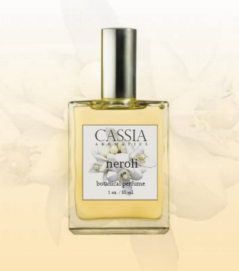 May include: A clear glass bottle of Cassia Aromatics neroli botanical perfume. The bottle has a silver cap and a white label with the brand name, product name, and description: "botanical perfume 1 oz./30 ml."