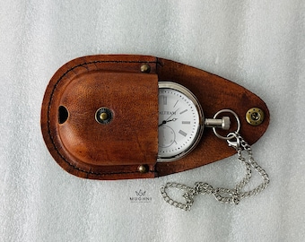 May include: A vintage pocket watch with a white face and black numerals, marked "WALTHAM", rests in a brown leather case. A silver chain is attached. The case is oval and has brass rivets.