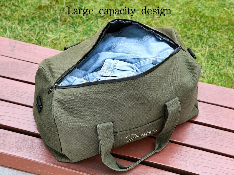 May include: A green canvas duffel bag with a zipper closure and a black strap. The bag is open and filled with blue denim clothing. The text "Large capacity design" is visible at the top of the image.
