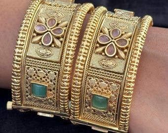 Emerald Bloom Rajwadi Kada - Gold polished bridal kada with floral pastel petal motifs and green square stones in embossed temple styling.