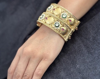Green and White Bloom Kada - Textured gold kada with round floral motifs, green center stones, and meenakari enamel detailing. Bridal-ready.