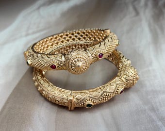 Rajasthani Shield Kada - Chunky openable kada with lattice work and beaded edge, featuring shield-style center button design and ruby studs.