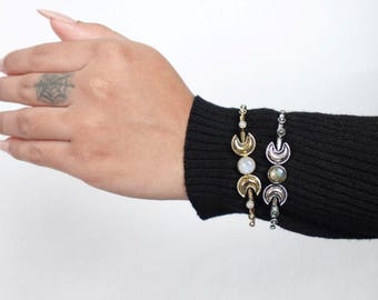 Double Moonstone Lunar Cuff Bracelet - Brass and silver cuffs with crescent moons and moonstones—mystical and chic.
