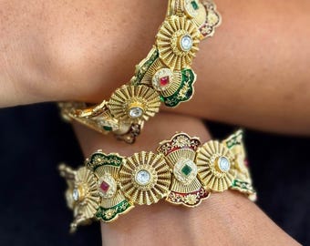 Sunburst Meenakari Kada-Openable gold kada with sun-shaped motifs, multicolor enamel fill, and polki-style stones in a festive Rajwadi look.