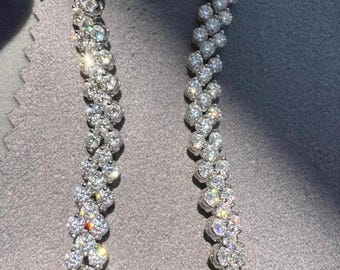 May include: A silver bracelet with a double row of sparkling diamonds set in a zig-zag pattern.