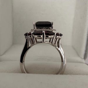 May include: A distressed wooden sign with the words "Welcome to our home" in white lettering. The sign has a rustic finish and a simple design, suitable for a porch or hallway.