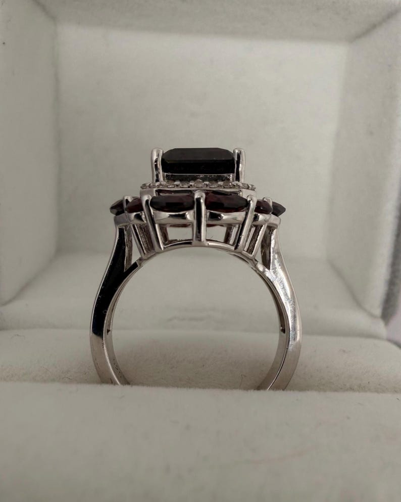 May include: A distressed wooden sign with the words "Welcome to our home" in white lettering. The sign has a rustic finish and a simple design, suitable for a porch or hallway.