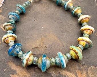 Beaded bracelet in blues and green, Czech Saturn beads