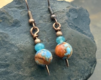 Dangle Earrings, Blue and Brick Red, on a copper wire with a faceted blue glass bead