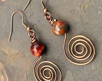 Faceted Carnelian gemstone on copper wire with swirl pattern