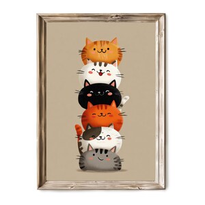 May include: A framed print featuring a stack of cartoon cats in various colors. The cats are orange, white, black, and gray, with smiling faces and striped tails. The artwork has a whimsical and playful style, perfect for a children's room or cat lover.