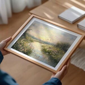 May include: A framed painting of a landscape with a river flowing through a field of wildflowers. The sky is a soft pink and blue, and there are a few birds flying overhead.