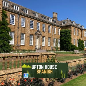 May include: Exterior view of Upton House, a large, historic building with many windows and a stone facade. A sign at the bottom reads "UPTON HOUSE SPANISH". The building is surrounded by a well-manicured lawn and garden.