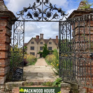 May include: An open, ornate black wrought iron gate leads to a stone path and a large, light-colored building. The gate is flanked by brick pillars. The sky is blue with clouds. A sign at the bottom reads "PACKWOOD HOUSE SPANISH".