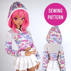 May include: A sewing pattern for a colorful camouflage hoodie with a mesh panel. The hoodie has a drawstring hood and long sleeves. The pattern is for a doll or action figure.