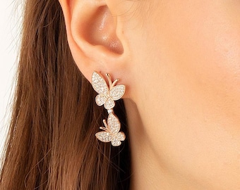 Embrace the beauty of transformation with these gorgeous silver butterfly earrings, featuring sparkling stones that add a radiant shine-14 K