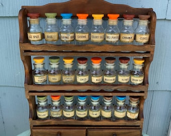 Vintage Complete Spice Rack, 3 Tiers and 24 Bottles, all present & in good used condition.