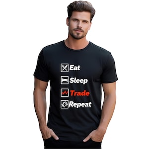 Pode incluir: Camiseta preta com um gráfico branco que diz "Comer, Dormir, Negociar, Repetir". A palavra "Negociar" está em vermelho.