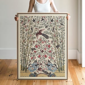 May include: A framed art print with a detailed floral and bird design. The artwork features a central bird with a long tail, surrounded by bamboo stalks, red flowers, and smaller birds. The color palette includes beige, red, blue, and black.