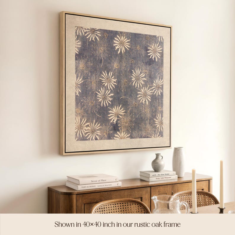 May include: A framed artwork with a blue and beige floral pattern. The artwork is displayed in a rustic oak frame, measuring 40 x 40 inches. The image shows the artwork above a wooden cabinet with books and decorative items.