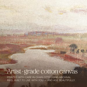 May include: A cotton canvas print with a landscape scene. The artwork features a river or stream in the foreground, with beige, brown, and red hues. The text "Artist-grade cotton canvas" is displayed at the bottom of the image.