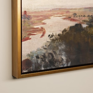 May include: An oil painting of a landscape with a river flowing through a valley. The artwork uses a warm colour palette with shades of red, brown, and green. The painting is framed in a gold-coloured wooden frame.