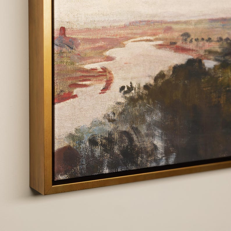 May include: An oil painting of a landscape with a river flowing through a valley. The artwork uses a warm colour palette with shades of red, brown, and green. The painting is framed in a gold-coloured wooden frame.